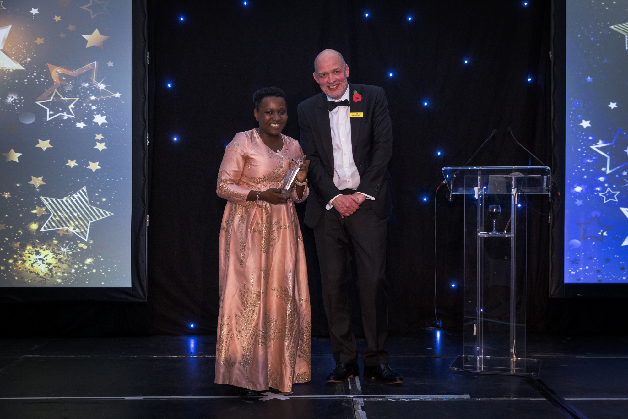 Liz onstage with the Trust's Chief Executive, Simon Morritt, to receive her award.